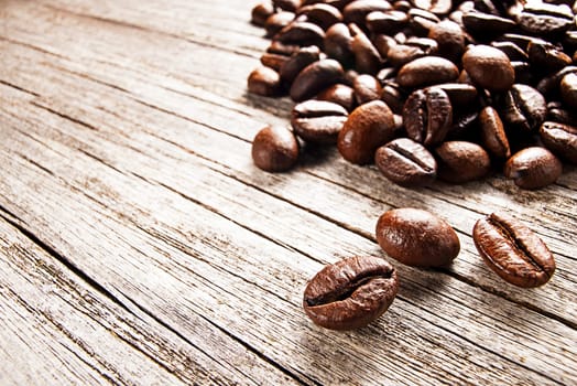 Roasted coffee beans on wooden background
