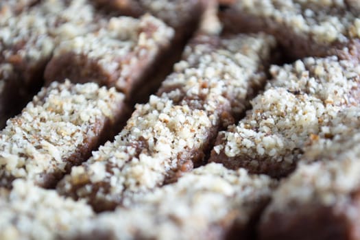 Close up of chocolate cake with walnut cut into squares