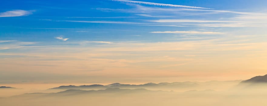 Mountain silhoutte over clouds, sky background, wallpaper