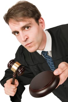 Oblique upper body view of a young man against a white background in a black robe with a judge's hammer and first glance into the camera.