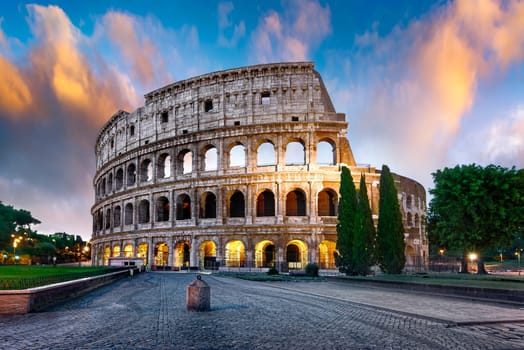 Colosseum in Rome at sunset with lights, Italy