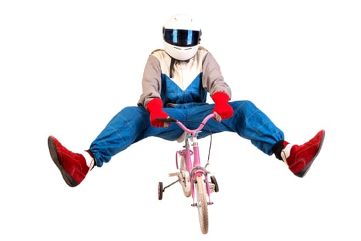 Racing driver posing with young girl's pink bicycle isolated in white