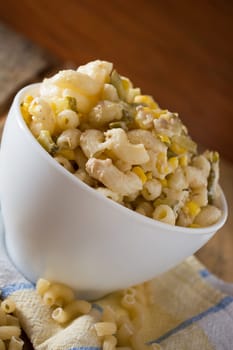 Close up of a salad with pasta, yellow corn and Italian seasonings.