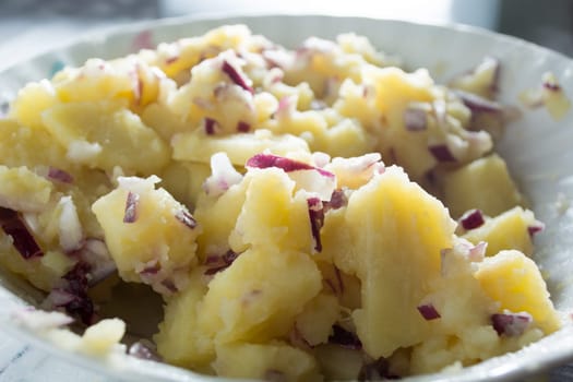 Potato salad with onions  (Selective Focus, Focus one third into the bowl)
