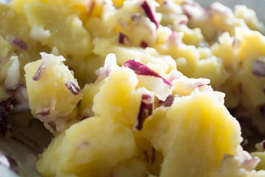 Potato salad with onions  (Selective Focus, Focus one third into the bowl)