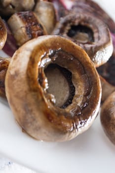 Roasted mushrooms with onion on white plate