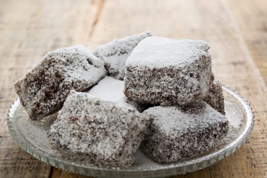 Close up of chocolate cakes with coconut flour on the glass plate