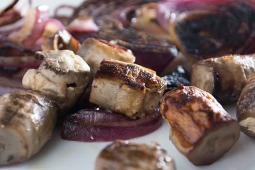 Roasted mushrooms with onion on white plate