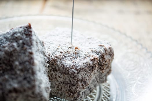 Close up of chocolate cakes with coconut flour on the glass plate