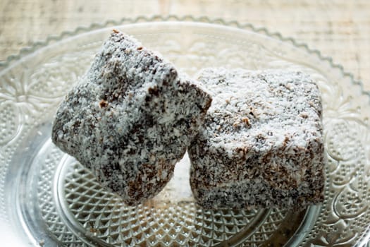 Close up of chocolate cakes with coconut flour on the glass plate