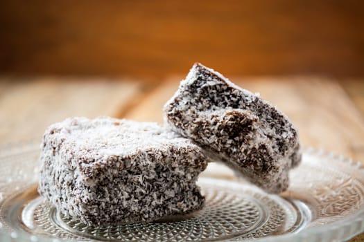 Close up of chocolate cakes with coconut flour on the glass plate