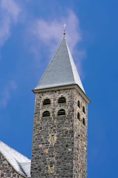 Tower,spire of a church in Antfeld in the Sauerland,Germany in front of a blue sky.