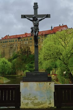 Crucifix in Krumlov in the Background of a Castle