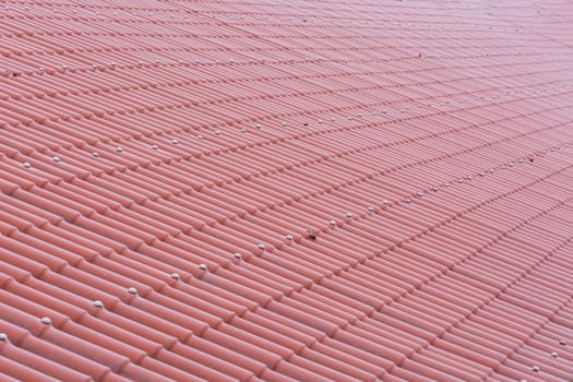 Pattern of a red tiled roof made of plastic sheets..