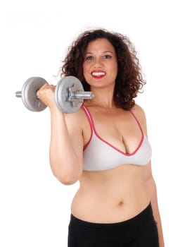 A beautiful young woman in exercising outfit lifting a dumbbell and .smiling in closeup, isolated for white background..