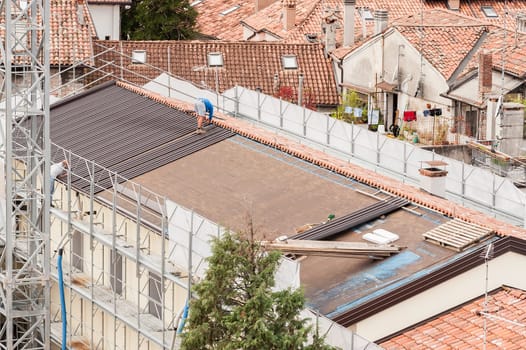 Workers in the construction of a roof.  Building renovation.