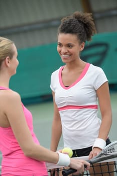 portrait of a tennis couple speaking outdoors