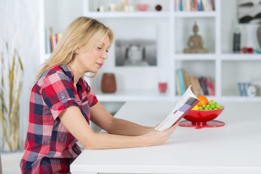 senior woman reading a book at homerelaxing time