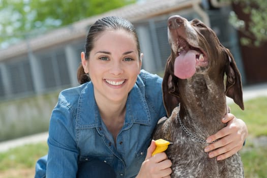 female vet stroking dog at animal shelter
