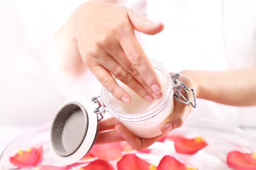 Cosmetic procedure,hand scrub. Beauty salon,manicure with hand scrub Jar with a cosmetic preparation spa & wellness. Massage of women's hands with spa peeling preparation & wellness