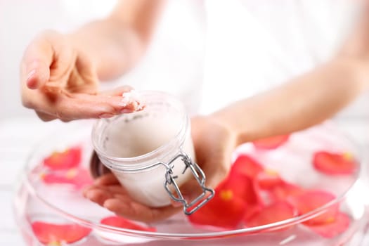 Cosmetic procedure,hand scrub. Beauty salon,manicure with hand scrub Jar with a cosmetic preparation spa & wellness. Massage of women's hands with spa peeling preparation & wellness