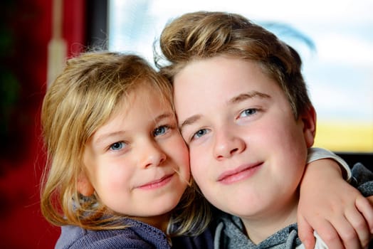 brother and sister together looking friendly in to the camera