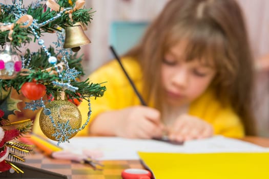Carried away by a girl making Christmas crafts, focusing on the fur-tree