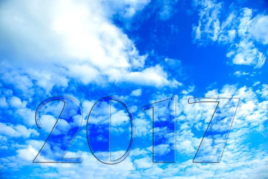 new year- 2017 in front of blue cloudy sky