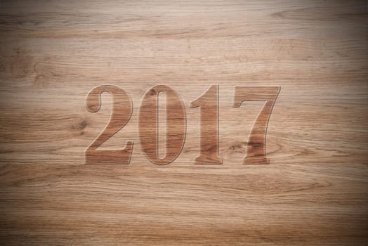 new year- 2017 on brown wooden ground