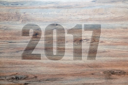 new year- 2017 on brown wooden ground