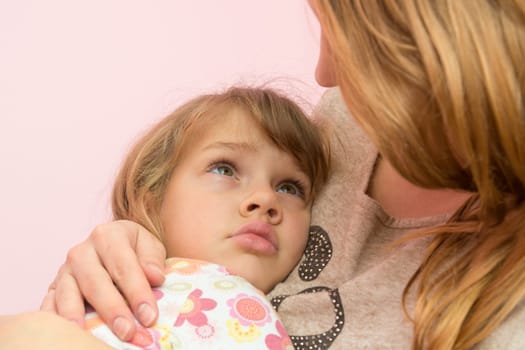 Mom comforting five-year daughter