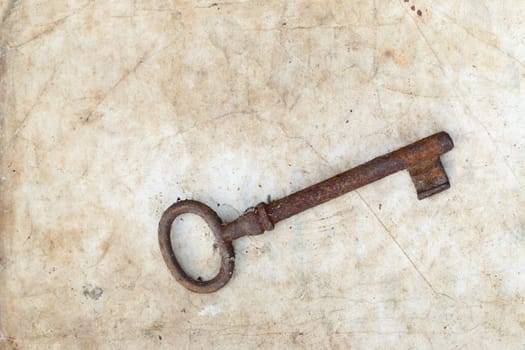 Detail of the rusty key on old parchment