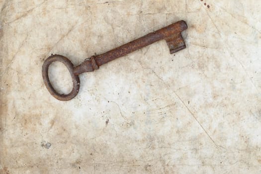 Detail of the rusty key on old parchment