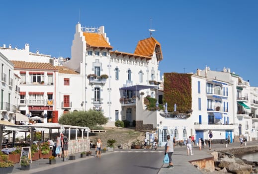 Beach promenade with tourists in Cadaques, spain