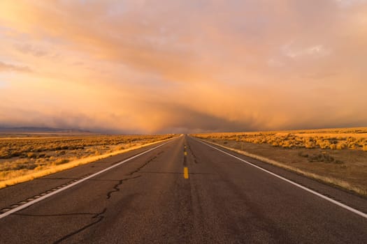 A side road off the interstate stormy skies at sunset