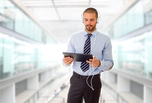 businessman with tablet pc and headphones, at the office