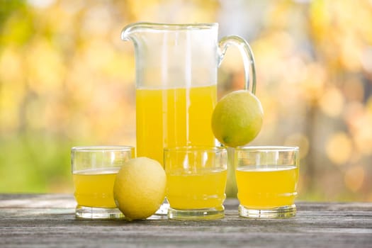 lemon juice on a wooden table, autumn set, outdoor