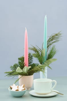 Christmas coffee table in pastels with candles, fir green and cinnamon stars