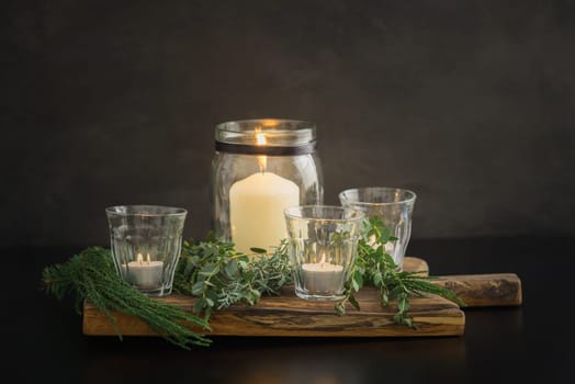 Christmas candle decoration with fir green, conifer, eucalyptus and olive tree branches