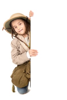 Young girl with Safari clothes behind a white board isolated in white