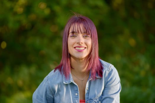 portrait of a young woman with green eyes and red hairs, outdoors