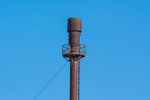 Chimney for controlled burning of excess gas.