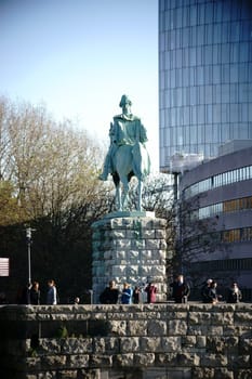 Cologne,Germany - November 24,2016: Visitors stand under an equestrian statue of a Prussian king on a viewing platform of the Hohenzollern Bridge on November 24,2016 in Cologne.