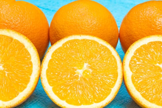 Orange and lemon citrus fruit pattern on light blue background