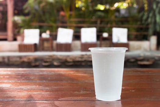 Glass of water on wooden table, stock photo