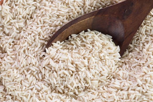 Wooden spoon scooping brown rice