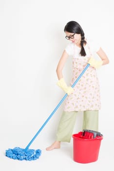 Young Asian housewife mopping floor with water, home cleaning.