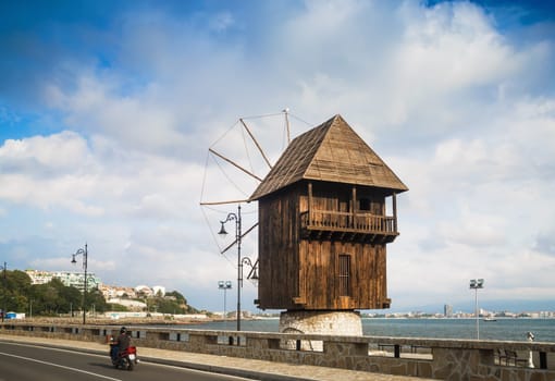 Nesebar, Bulgaria - September 05, 2014: Old windmill in Nessebar in Bulgaria. Ancient wooden mill. Sunny summer day. Nesebar is an ancient town on the Bulgarian Black Sea Coast. UNESCO world heritage site.