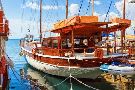 Nesebar, Bulgaria - September 06, 2013: Wooden passenger pleasure ship standing at the pier in the port of the old town of Nessebar on the Black Sea coast. Sunny summer day.