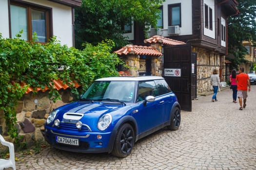 Nesebar, Bulgaria - September 06, 2014: Blue car Mini Cooper in a narrow street of the old town of Nessebar, Bulgaria.